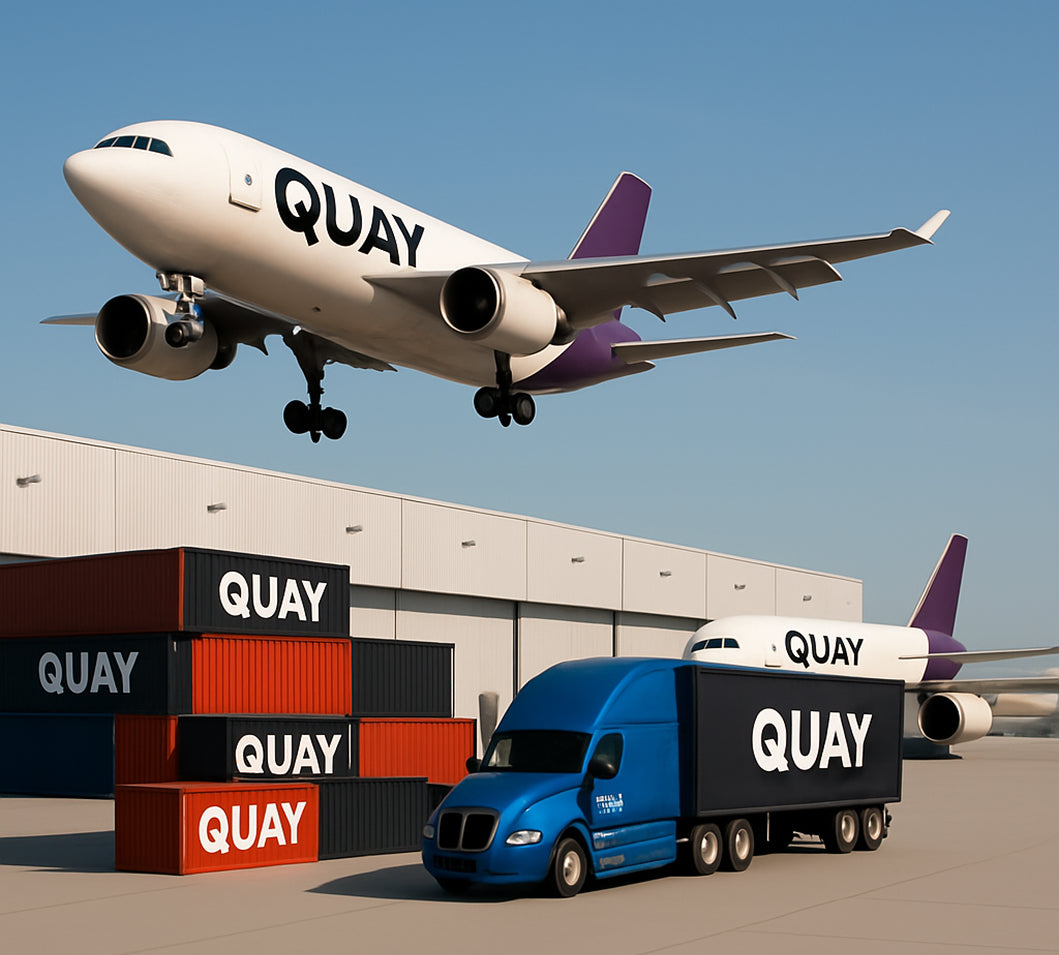 Airplane, truck, and containers with 'QUAY' branding in front of a building representing global enterprise growth